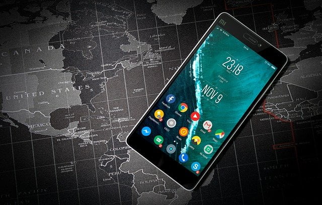 Phone on top of a world map Image by Pexels from Pixabay 
