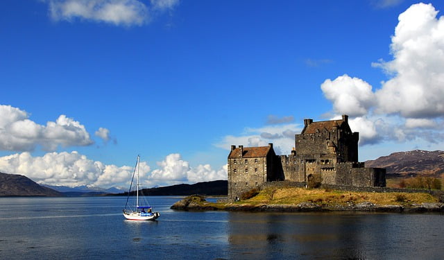 Scottish castle with sailboat views on the water by pixabay user Collie581