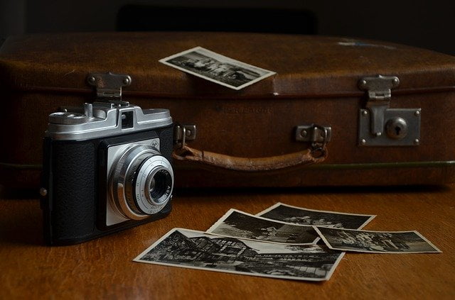 Vintage camera, luggage and postcards Image by congerdesign from Pixabay 