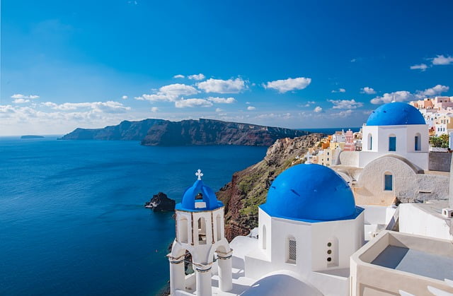 Santorini church views with cliff and blue waters Image by Russell_Yan from Pixabay 