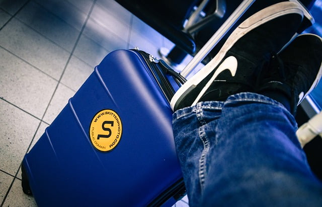 Feet on suitcase waiting for flight Image by Rudy and Peter Skitterians from Pixabay 