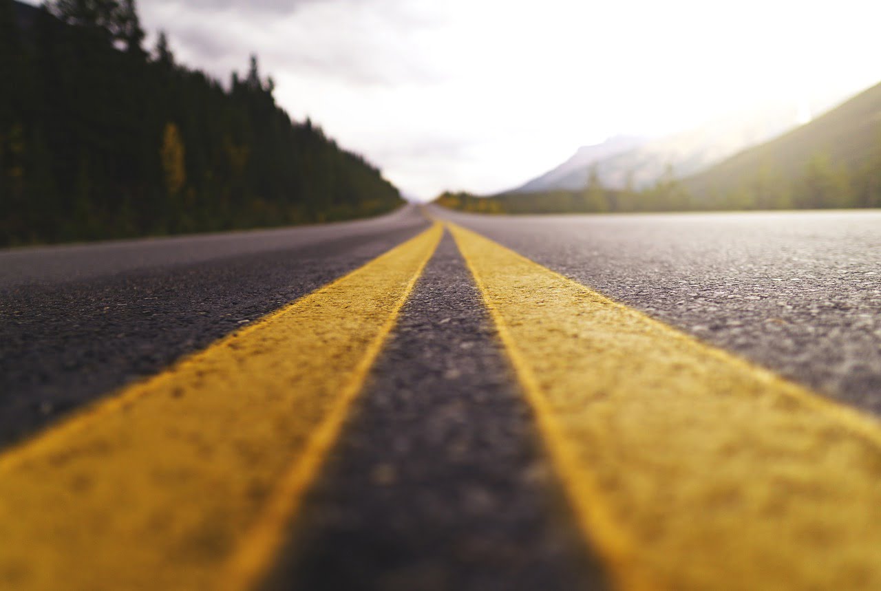 Lines on the road of a highway by pixabay user JoshuaWoroniecki