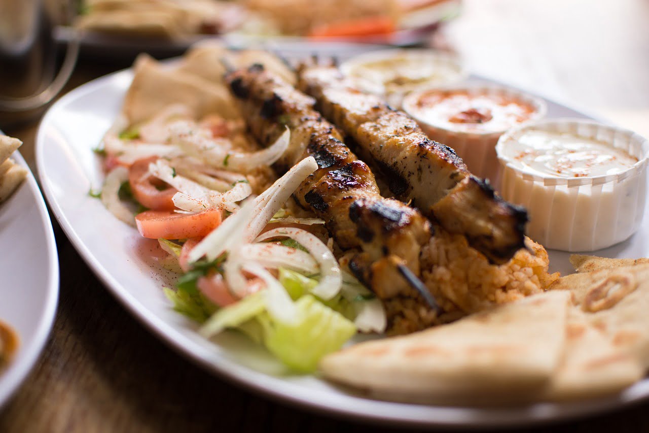 Souvlaki platter with bread and dips by pixabay user jcvelis