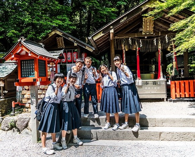 Japanese students posing by a temple in Japan